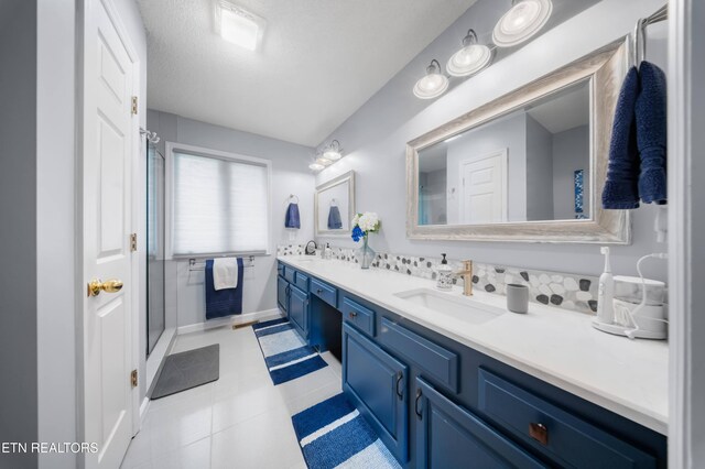 118 Motthaven Dr, Crossville, TN 38558 - bathroom with a shower stall, double vanity, baseboards, and tile patterned floors