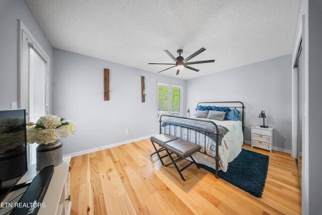 118 Motthaven Dr, Crossville, TN 38558 - bedroom with a textured ceiling, wood finished floors, baseboards, and a ceiling fan