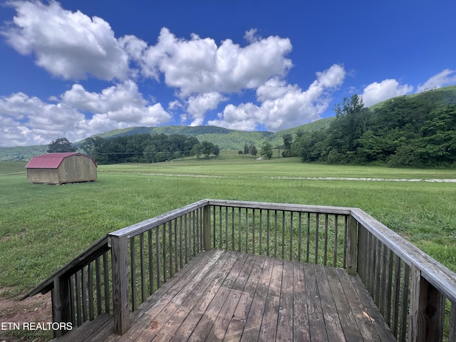 225 Orange Ln, Speedwell, TN 37870 - wooden terrace with a shed, an outbuilding, a lawn, a mountain view, and a rural view