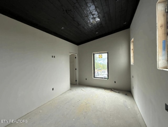 spare room with wooden ceiling and vaulted ceiling