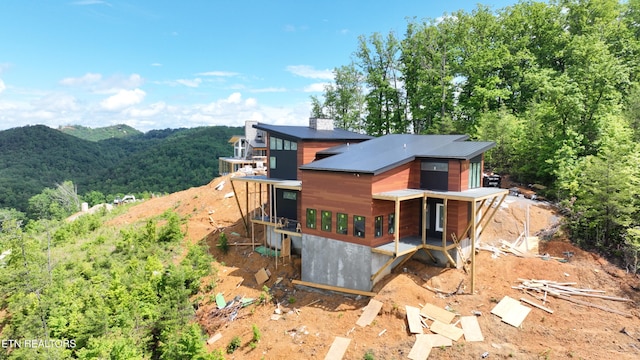 rear view of house featuring metal roof