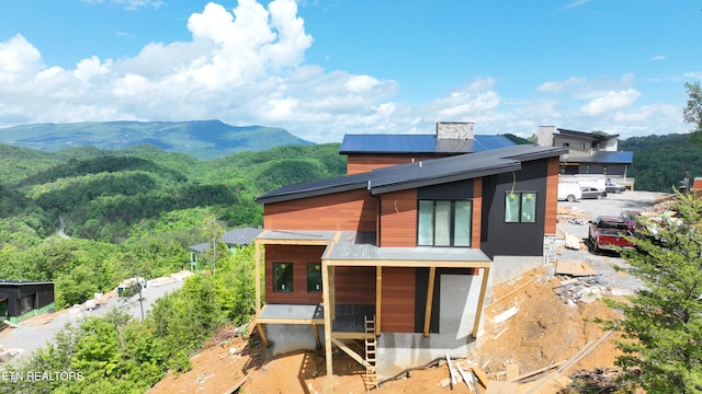 rear view of property featuring a mountain view