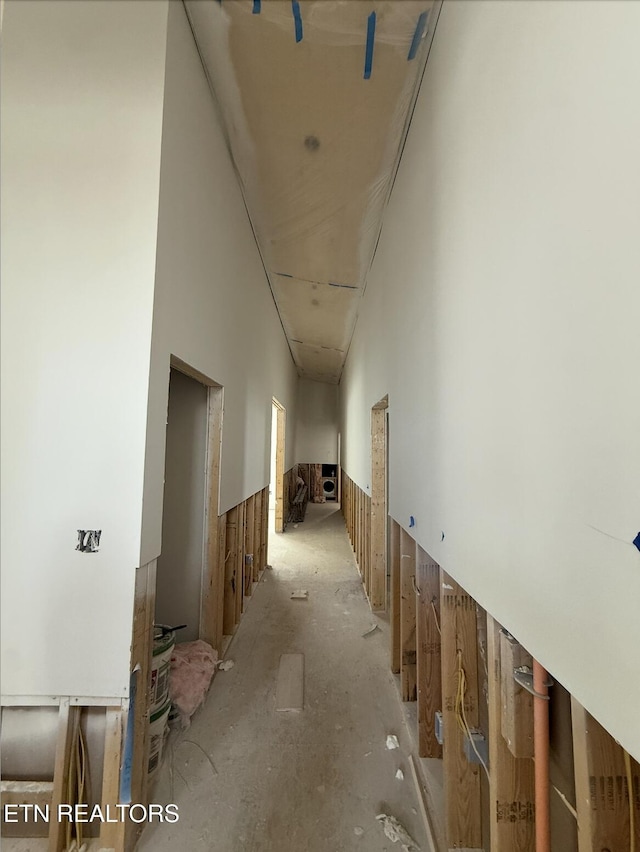 hallway featuring a towering ceiling