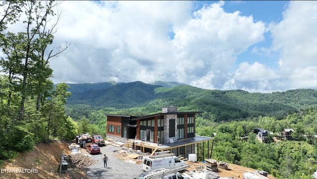 view of mountain background with a heavily wooded area