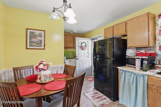 138 Robinson Ln, Middlesboro, KY 40965 - kitchen featuring freestanding refrigerator, light countertops, a chandelier, stainless steel microwave, and hanging light fixtures