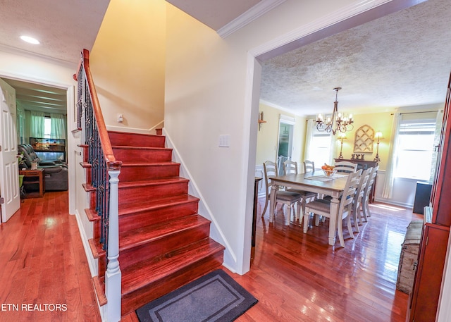 112 Chestnut Hill Rd, Oak Ridge, TN 37830 - stairway featuring wood finished floors, ornamental molding, a chandelier, baseboards, and a textured ceiling