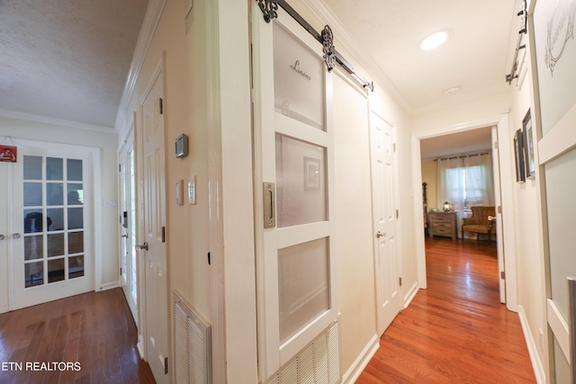 112 Chestnut Hill Rd, Oak Ridge, TN 37830 - hall featuring light wood-type flooring, ornamental molding, and a barn door