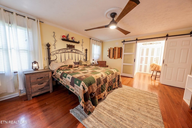 112 Chestnut Hill Rd, Oak Ridge, TN 37830 - bedroom featuring a barn door, ornamental molding, wood finished floors, and ceiling fan
