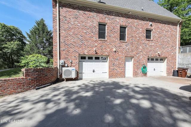 112 Chestnut Hill Rd, Oak Ridge, TN 37830 - view of home's exterior featuring driveway, a garage, ac unit, brick siding, and a shingled roof