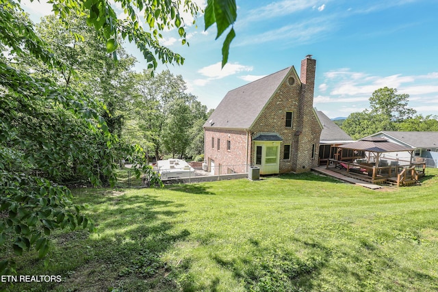 112 Chestnut Hill Rd, Oak Ridge, TN 37830 - back of house featuring a gazebo, brick siding, a chimney, a wooden deck, and a shingled roof