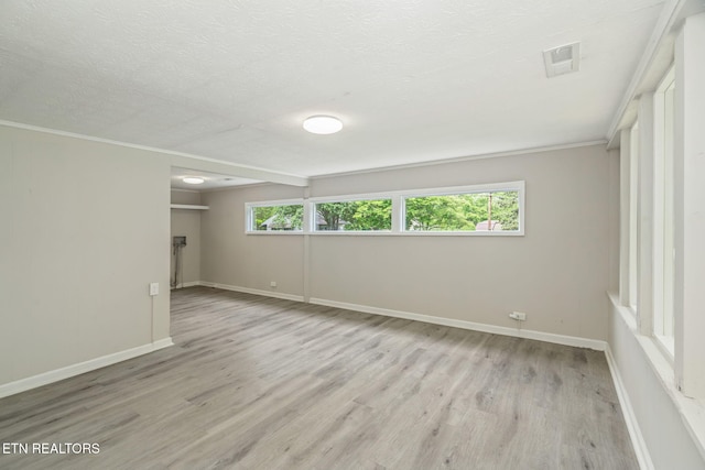 707 W Outer Dr, Oak Ridge, TN 37830 - spare room with wood finished floors, baseboards, a textured ceiling, and ornamental molding