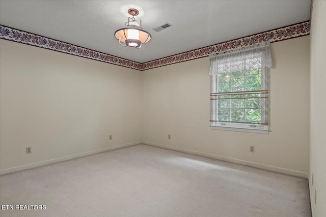 empty room with light carpet and baseboards