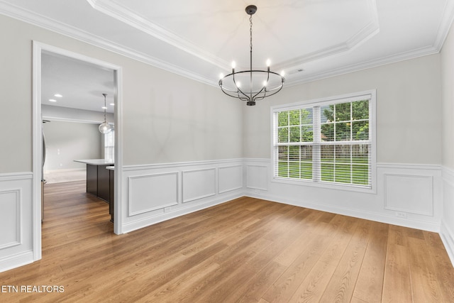 12888 Lily Pond Ln, Knoxville, TN 37922 - unfurnished dining area featuring a chandelier, a wainscoted wall, light wood finished floors, ornamental molding, and a raised ceiling