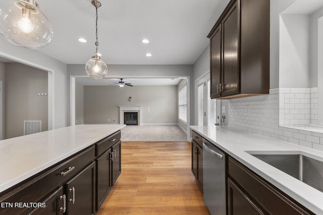 12888 Lily Pond Ln, Knoxville, TN 37922 - kitchen featuring stainless steel dishwasher, a ceiling fan, a glass covered fireplace, decorative light fixtures, and recessed lighting