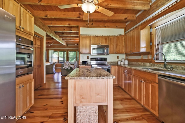 871 Poplar Creek Rd, Oliver Springs, TN 37840 - kitchen featuring appliances with stainless steel finishes, a sink, light wood finished floors, wood ceiling with exposed beams, and a center island