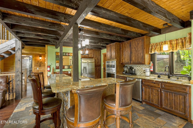529 Deer Path Ln, Gatlinburg, TN 37738 - kitchen featuring stainless steel appliances, a sink, tasteful backsplash, beam ceiling, and light stone counters