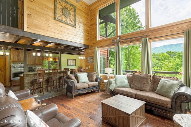 529 Deer Path Ln, Gatlinburg, TN 37738 - living room with a towering ceiling, wooden walls, healthy amount of natural light, and dark wood-style flooring