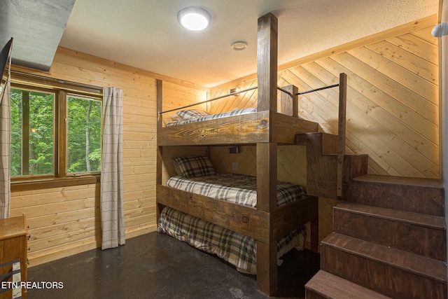 529 Deer Path Ln, Gatlinburg, TN 37738 - bedroom with wood walls and concrete floors