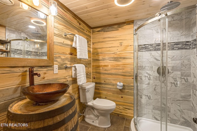 529 Deer Path Ln, Gatlinburg, TN 37738 - bathroom with wooden walls, a shower stall, a sink, tile patterned flooring, and wooden ceiling