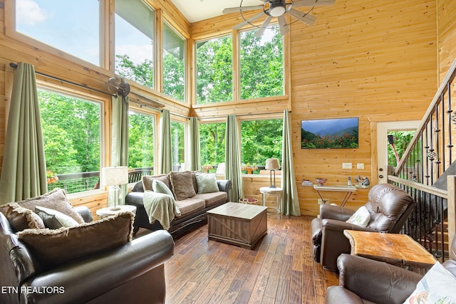 529 Deer Path Ln, Gatlinburg, TN 37738 - living room featuring a towering ceiling, a ceiling fan, wood walls, hardwood / wood-style flooring, and stairs