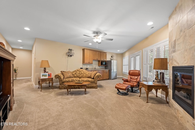 115 Tecumseh Ln, Loudon, TN 37774 - living room featuring light colored carpet, baseboards, a ceiling fan, a tiled fireplace, and recessed lighting