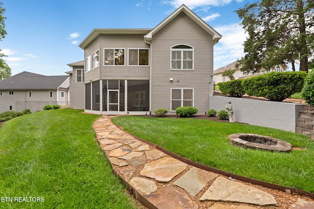 115 Tecumseh Ln, Loudon, TN 37774 - rear view of property featuring a fire pit, a lawn, and a sunroom