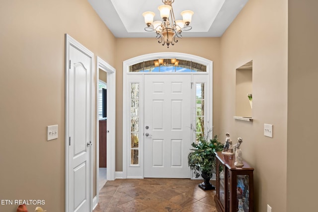 115 Tecumseh Ln, Loudon, TN 37774 - foyer featuring a chandelier, baseboards, and stone finish flooring