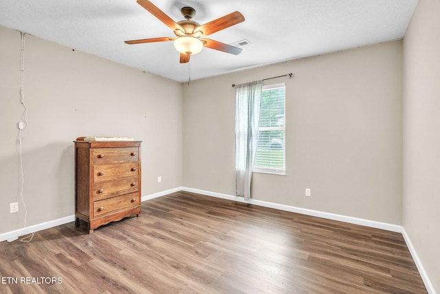 unfurnished bedroom featuring wood finished floors and baseboards