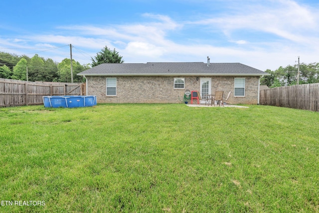 rear view of house with brick siding and a patio