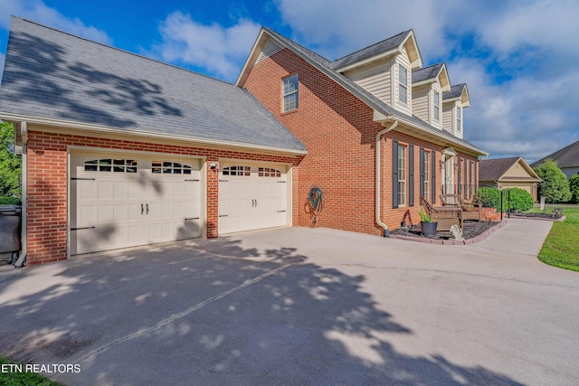 312 Cheestana Way, Loudon, TN 37774 - view of property exterior with brick siding, driveway, a garage, and a shingled roof