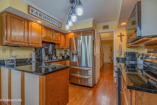 312 Cheestana Way, Loudon, TN 37774 - kitchen with stainless steel appliances, crown molding, a peninsula, light wood-style floors, and brown cabinets
