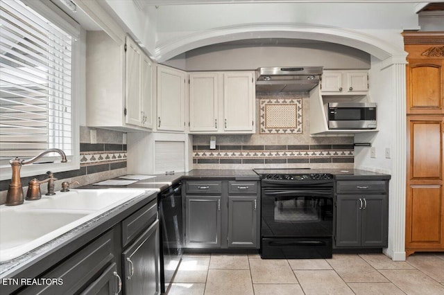 700 Shanghai Landing Ln Unit 11, Lafollette, TN 37766 - kitchen with black appliances, a sink, white cabinets, and light tile patterned floors