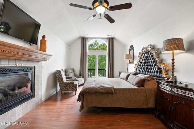 700 Shanghai Landing Ln Unit 11, Lafollette, TN 37766 - bedroom featuring dark wood finished floors, vaulted ceiling, a tiled fireplace, and a ceiling fan