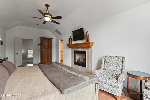 700 Shanghai Landing Ln Unit 11, Lafollette, TN 37766 - living room with vaulted ceiling, ceiling fan, a tiled fireplace, wood finished floors, and baseboards