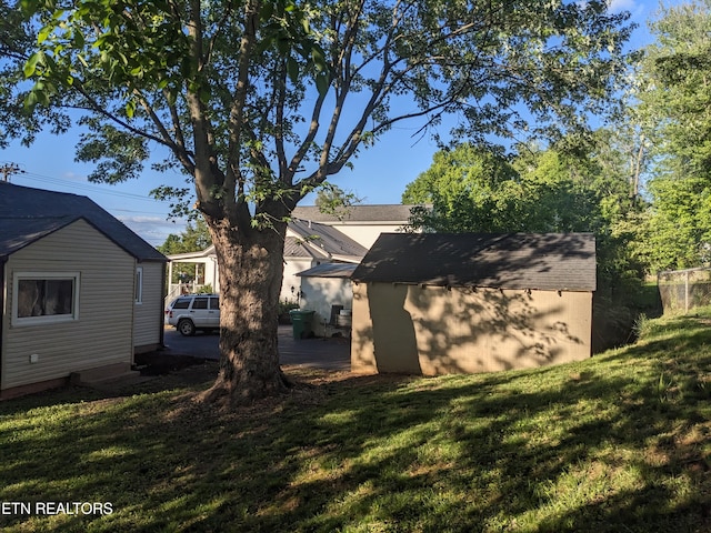 628 Algonquin Dr, Morristown, TN 37813 - back of property with a storage unit, an outdoor structure, and a lawn