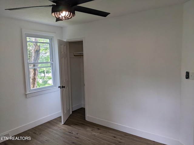 628 Algonquin Dr, Morristown, TN 37813 - unfurnished bedroom with baseboards, multiple windows, wood finished floors, and a closet