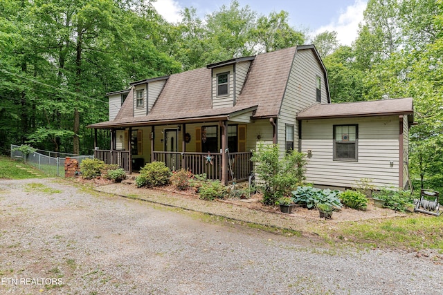 103 Renner Ln, Oliver Springs, TN 37840 - colonial inspired home featuring a porch, a gambrel roof, roof with shingles, and fence