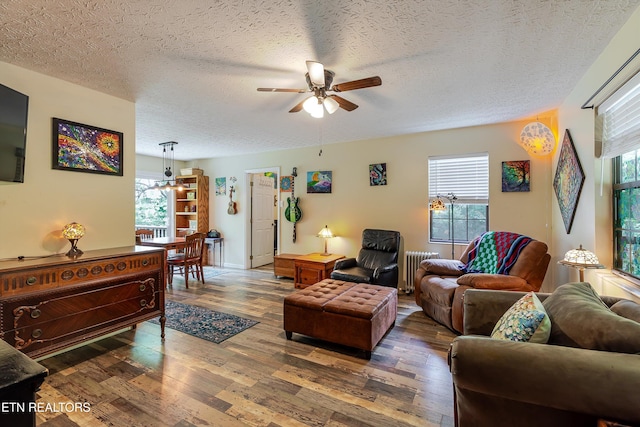 103 Renner Ln, Oliver Springs, TN 37840 - living room featuring a ceiling fan, wood finished floors, a textured ceiling, and radiator heating unit