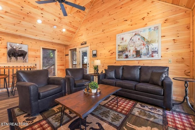 living area with lofted ceiling, wood finished floors, wooden walls, a ceiling fan, and recessed lighting