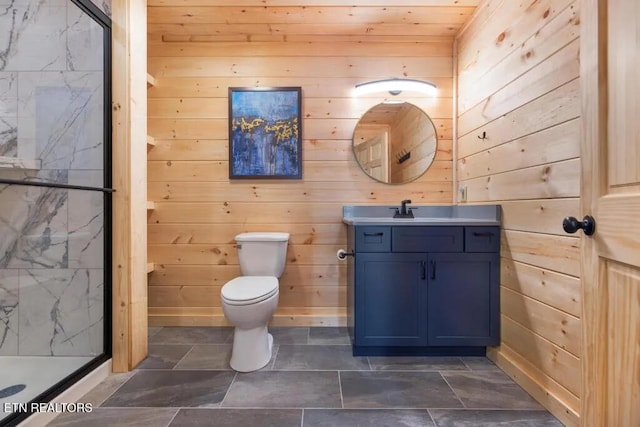 full bath with a marble finish shower, wooden walls, vanity, and toilet