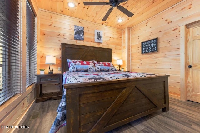 bedroom featuring wooden ceiling, dark wood finished floors, wood walls, and recessed lighting