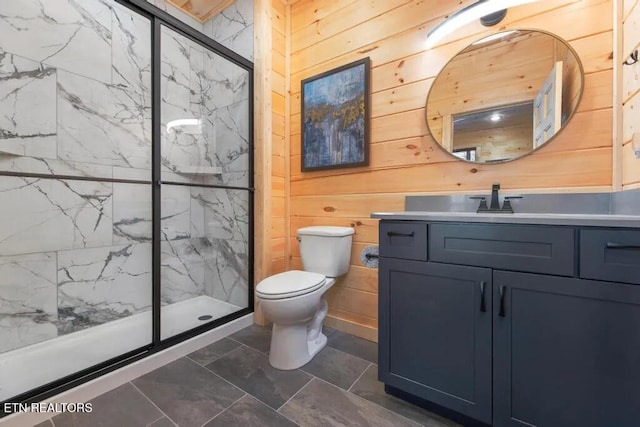 bathroom with wood walls, a marble finish shower, toilet, and vanity