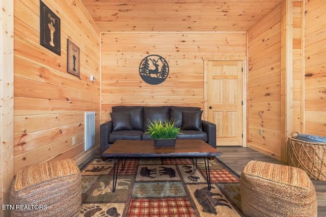 living area featuring wooden walls and wood finished floors