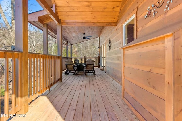 wooden deck with ceiling fan and outdoor dining area