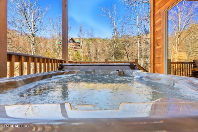 wooden deck featuring a hot tub