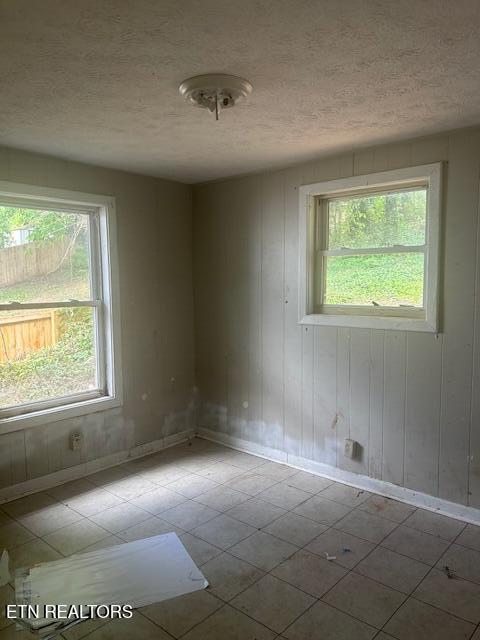 3614 Selma Ave, Knoxville, TN 37914 - unfurnished room featuring baseboards, a textured ceiling, and tile patterned floors