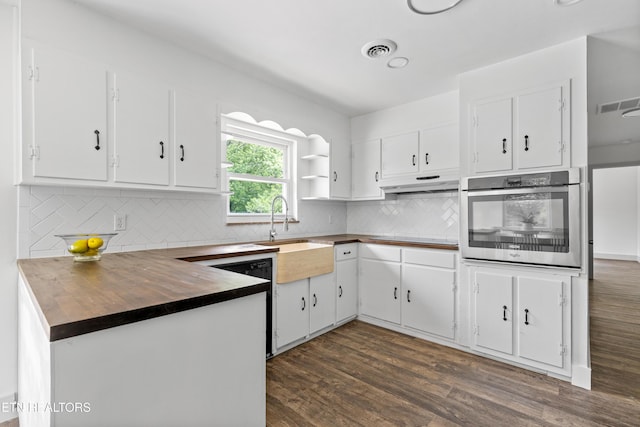 4525 Fawnie Ln, Knoxville, TN 37918 - kitchen with stainless steel oven, a sink, dark wood finished floors, under cabinet range hood, and white cabinets