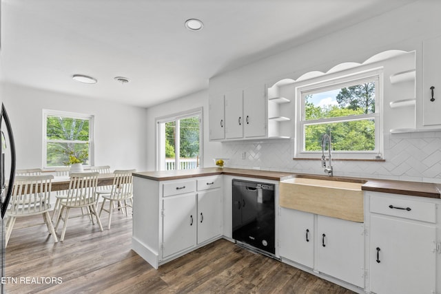 4525 Fawnie Ln, Knoxville, TN 37918 - kitchen featuring butcher block countertops, black dishwasher, open shelves, tasteful backsplash, and a sink