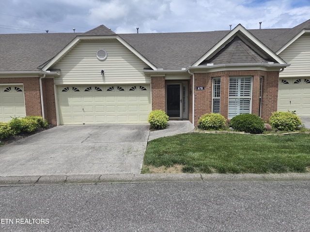 678 Applegate Ln Unit 33, Knoxville, TN 37934 - view of front facade featuring brick siding, concrete driveway, roof with shingles, and a garage