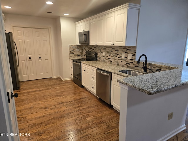678 Applegate Ln Unit 33, Knoxville, TN 37934 - kitchen featuring black appliances, white cabinets, light stone countertops, a peninsula, and recessed lighting